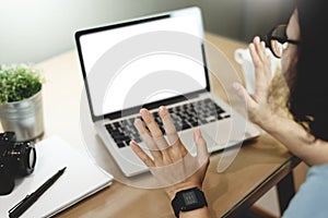 Asian Woman having video call with white blank screen on laptop computer while work from home