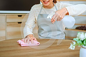 Asian woman with headache doing spring cleaning chores in her living room at home overworked housekeeping service