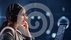 Asian woman in headphones big data analyzing online talking working laptop futuristic diagram screen