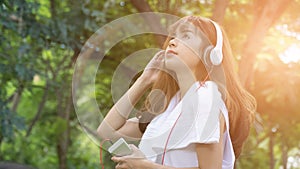 Asian woman with headphones. young female holding mobile smart