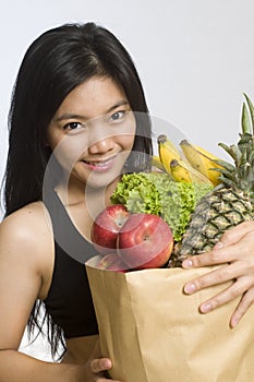 Asian woman with healthy fruits and vegetables