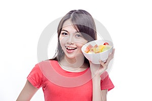 Asian woman holding bowl of fruit