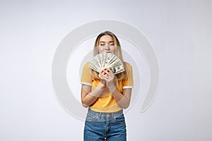 Asian woman holding cash notes isolated in white background. Young asian woman in white t-shirt in winning surprise