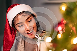 Asian woman holding Christmas ornament for decorate on christmas tree