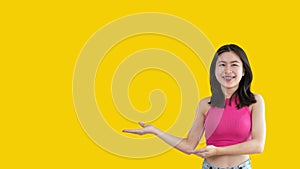 Asian woman with holding copyspace imaginary on the palm to insert an ad