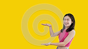 Asian woman with holding copyspace imaginary on the palm to insert an ad