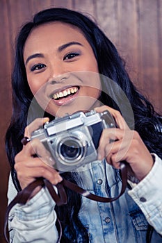 Asian woman holding digital camera