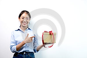 Asian woman holding a gift box Glad to be the giver of surprise with excitement, joy and smiles on the holidays, Christmas,