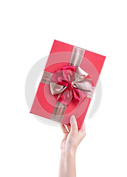 Asian woman holding, giving, sending a wrapped packaged gift box with tied bow-knot isolated on white background, clipping path,