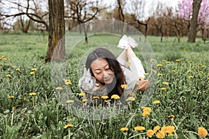 Asian woman holding healthy Lovely bunny fluffy rabbits on green field. The Easter hares.