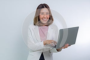 Asian woman holding a laptop computer, raising her hand with smile