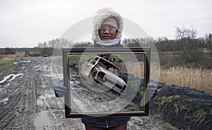 Asian Woman Holding Picture Frame With Stolen & Burnt Out Car Trick Photography.