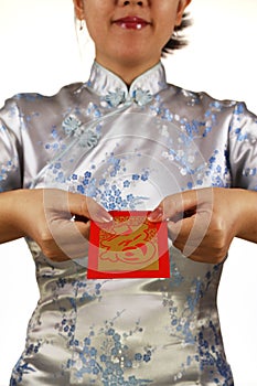 Asian woman holding red money packet or ang pow