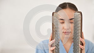 Asian woman holding sadhu boards on face background.