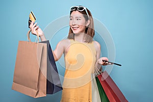 Asian woman are holding shopping bags with face happily