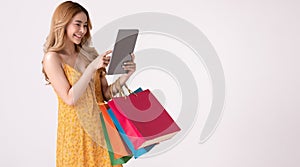 Asian woman holding  shoppingbag and shopping online on teblet photo