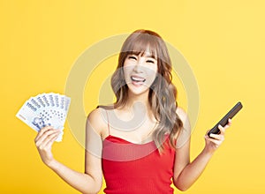 asian woman holding smartphone and money