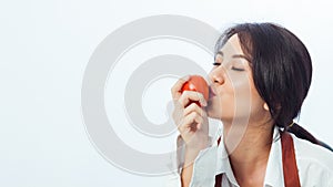 Asian woman holding vegetables and smiling on white background.