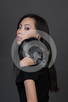 Asian woman holds grey chinchilla