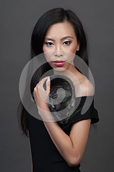 Asian woman holds grey chinchilla