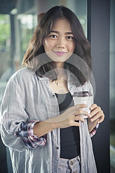 Asian woman and hot coffee cup in hand relaxing emotion smiling