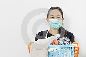 Asian Woman in a housekeeper looks wearing apron cleaning