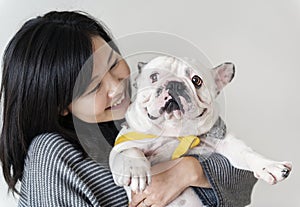 Asian woman hugging dog closeup photo