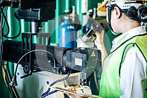 Asian woman is industrial engineer or QC team holding the clipboard