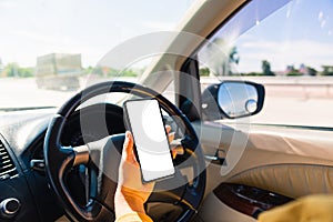 Woman inside a car and using a hand holding mobile smartphone blank screen while driving the car