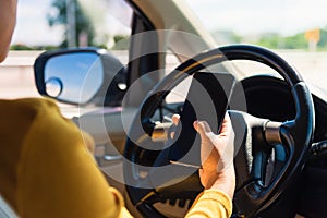 Woman inside a car and using a hand holding mobile smartphone