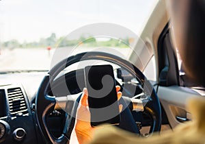 Woman inside a car and using a hand holding mobile smartphone