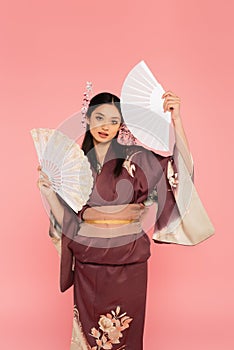 Asian woman in kimono holding fans