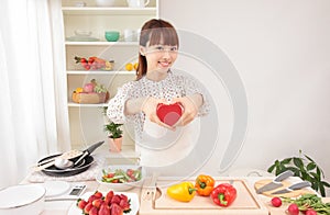 Asian woman in kitchen with space for copy