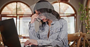 Asian woman, laptop and cafe with frustration and writing for blog or article. Journalist, coffee shop and stress for