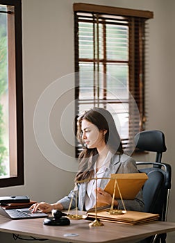 Asian woman lawyer working and gavel, tablet, laptop in front, Advice justice and law concept