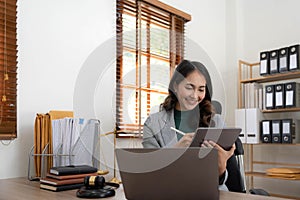 asian woman lawyer working and judge in a courtroom the gavel, working with tablet and laptop and digital tablet