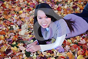 Asian Woman Laying in Leaves