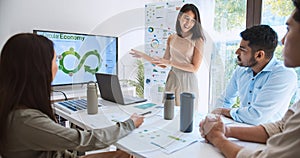 Asian woman lead young group of multiethnic businesspeople in team meeting, using laptop computer for ESG topic presentation