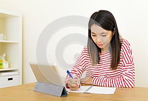 Asian woman learning through digital tablet