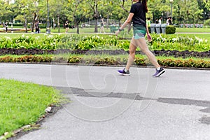 Asian woman legs doing exercise walking in the park in summer.
