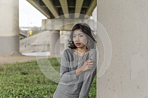 Asian Woman in lifestyle locations under a train track overpass