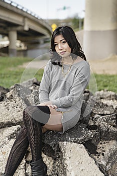 Asian Woman in lifestyle locations under a train track overpass