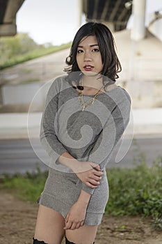 Asian Woman in lifestyle locations under a train track overpass