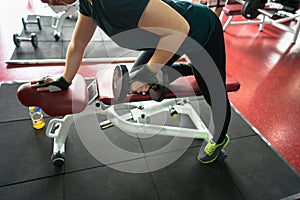 Asian Woman Lifting Dumbbells in Weight Training Fitness - Sport and Lifestyle Concept