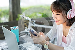 Asian woman listen online program