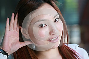 asian woman listening gossip close up