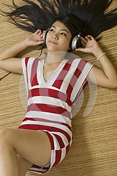 Asian woman listening to music