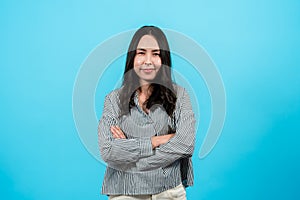 Asian woman with long hair wearing black white striped shirt, stood gestured with hands crossed over chest photo