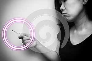 Asian woman looking at  clinical thermometer on her hand for checking temperature. With anxiety mood. Black and white tone with