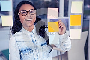 Asian woman looking at sticky notes